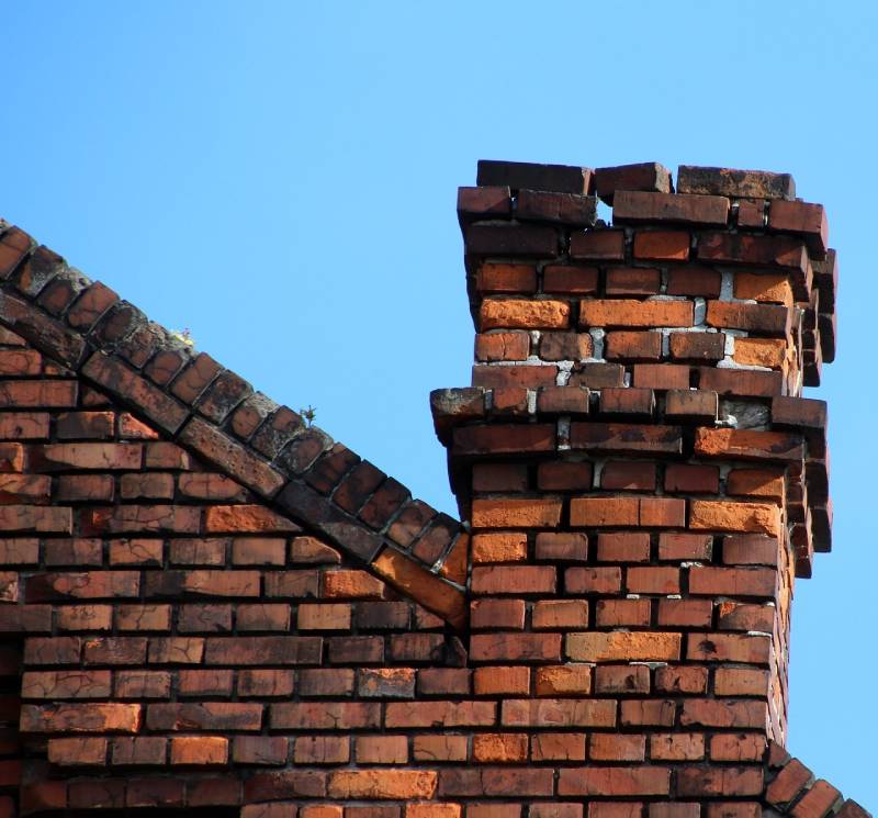 Damaged chimney on an Wayne home showing cracks and missing mortar